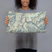 Person holding 20x12 Custom Granite Peak Montana Map Throw Pillow in Woodblock