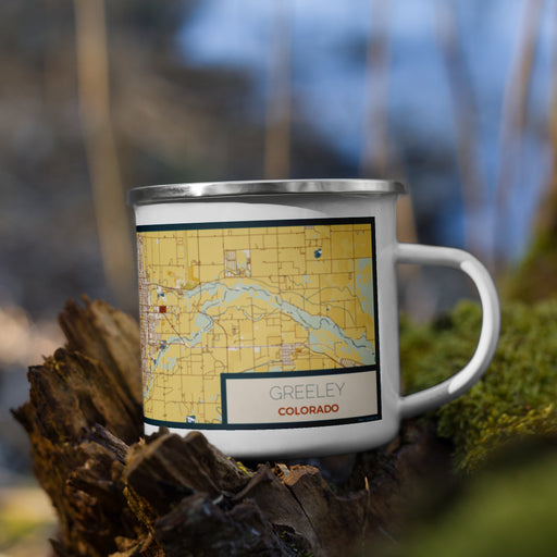 Right View Custom Greeley Colorado Map Enamel Mug in Woodblock on Grass With Trees in Background