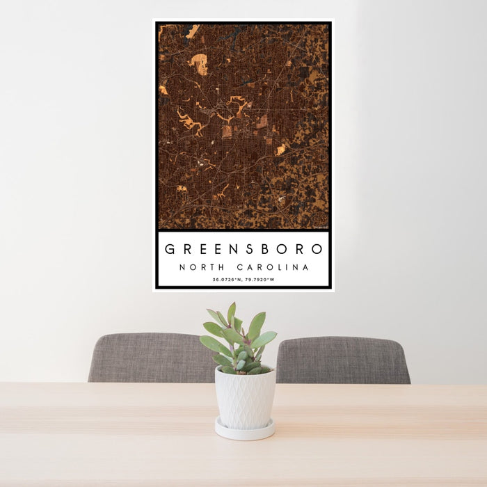 24x36 Greensboro North Carolina Map Print Portrait Orientation in Ember Style Behind 2 Chairs Table and Potted Plant