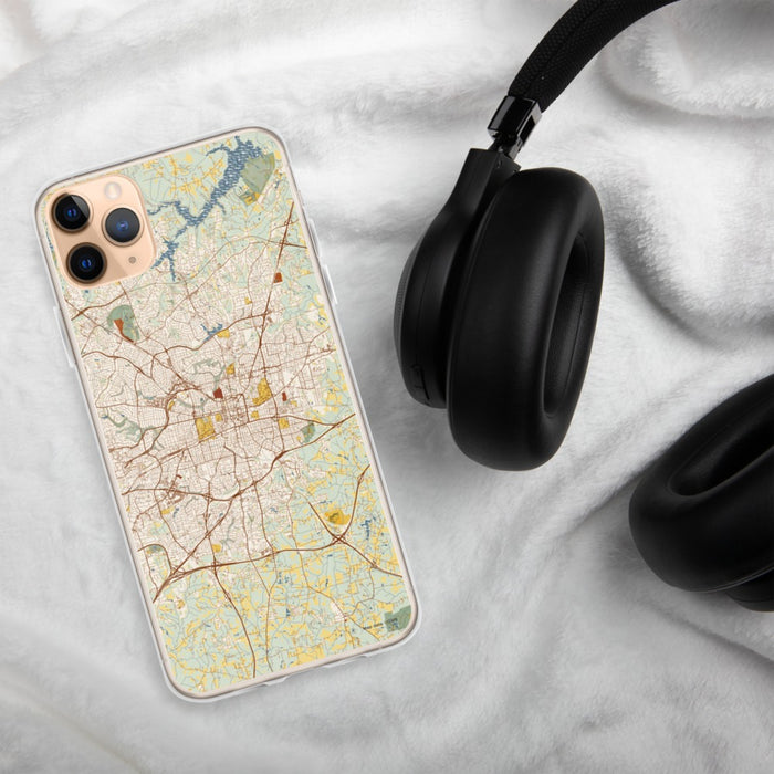 Custom Greensboro North Carolina Map Phone Case in Woodblock on Table with Black Headphones