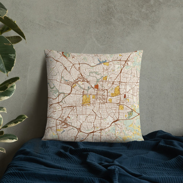 Custom Greensboro North Carolina Map Throw Pillow in Woodblock on Bedding Against Wall