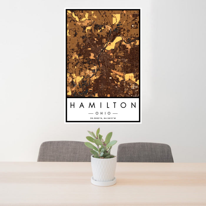 24x36 Hamilton Ohio Map Print Portrait Orientation in Ember Style Behind 2 Chairs Table and Potted Plant
