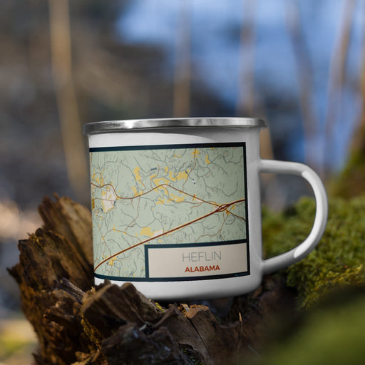 Right View Custom Heflin Alabama Map Enamel Mug in Woodblock on Grass With Trees in Background