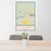 24x36 Hillman Michigan Map Print Portrait Orientation in Woodblock Style Behind 2 Chairs Table and Potted Plant