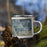 Right View Custom Homedale Idaho Map Enamel Mug in Afternoon on Grass With Trees in Background
