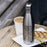 17oz Stainless Steel Insulated Cola Bottle with Custom Engraved Map on Table with Pastry and Sunglasses