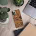 Custom Hygiene Colorado Map Phone Case in Ember on Table with Laptop and Plant