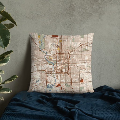 Custom Indianapolis Indiana Map Throw Pillow in Woodblock on Bedding Against Wall