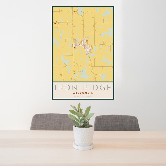 24x36 Iron Ridge Wisconsin Map Print Portrait Orientation in Woodblock Style Behind 2 Chairs Table and Potted Plant