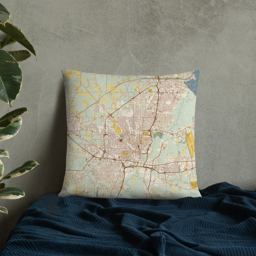 Custom Jackson Mississippi Map Throw Pillow in Woodblock on Bedding Against Wall