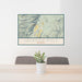 24x36 Jackson Hole Wyoming Map Print Landscape Orientation in Woodblock Style Behind 2 Chairs Table and Potted Plant