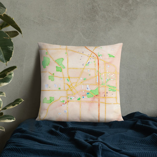 Custom Janesville Wisconsin Map Throw Pillow in Watercolor on Bedding Against Wall