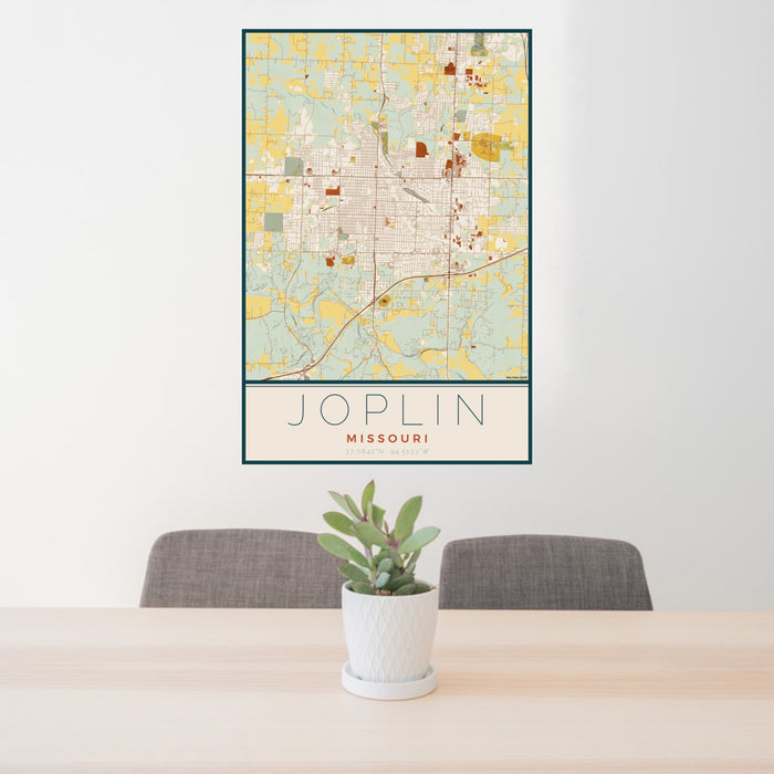 24x36 Joplin Missouri Map Print Portrait Orientation in Woodblock Style Behind 2 Chairs Table and Potted Plant