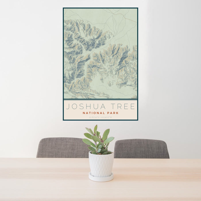 24x36 Joshua Tree National Park Map Print Portrait Orientation in Woodblock Style Behind 2 Chairs Table and Potted Plant