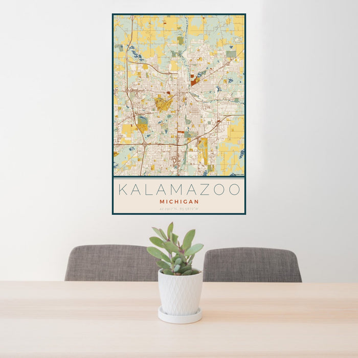 24x36 Kalamazoo Michigan Map Print Portrait Orientation in Woodblock Style Behind 2 Chairs Table and Potted Plant