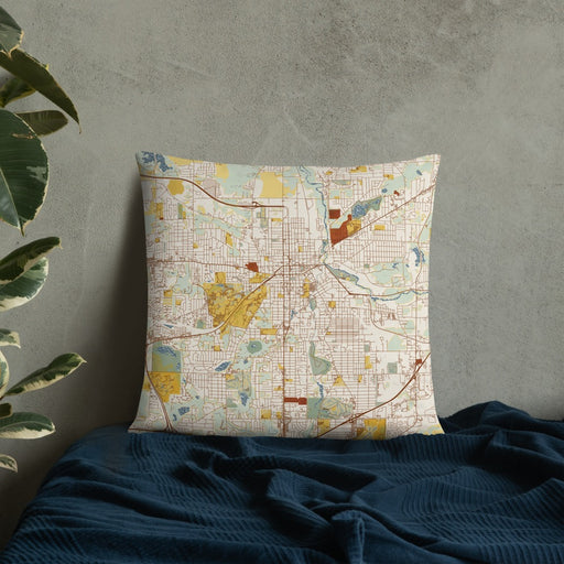 Custom Kalamazoo Michigan Map Throw Pillow in Woodblock on Bedding Against Wall