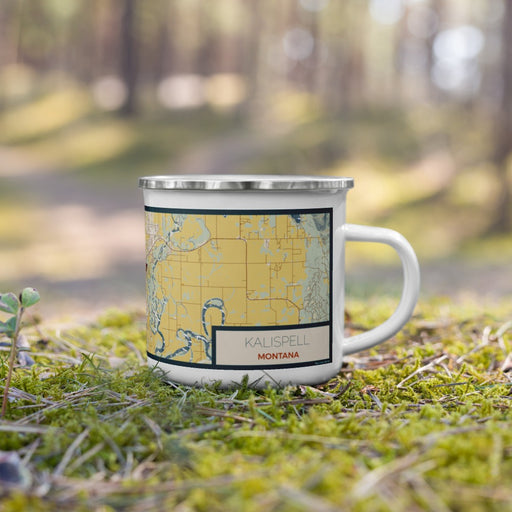 Right View Custom Kalispell Montana Map Enamel Mug in Woodblock on Grass With Trees in Background