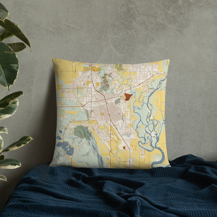 Custom Kalispell Montana Map Throw Pillow in Woodblock on Bedding Against Wall