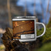 Right View Custom Kearney Nebraska Map Enamel Mug in Ember on Grass With Trees in Background