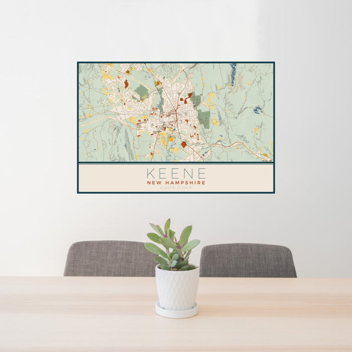 24x36 Keene New Hampshire Map Print Lanscape Orientation in Woodblock Style Behind 2 Chairs Table and Potted Plant