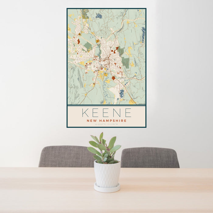24x36 Keene New Hampshire Map Print Portrait Orientation in Woodblock Style Behind 2 Chairs Table and Potted Plant