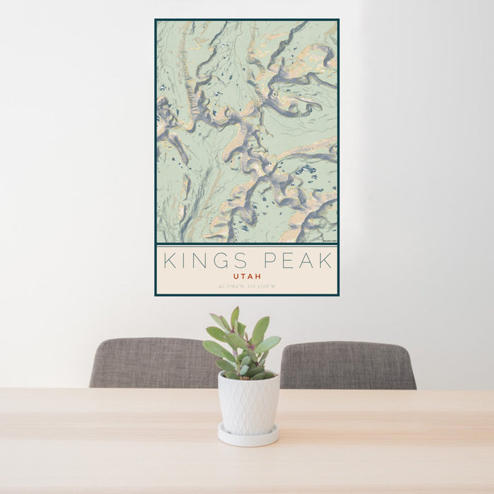 24x36 Kings Peak Utah Map Print Portrait Orientation in Woodblock Style Behind 2 Chairs Table and Potted Plant