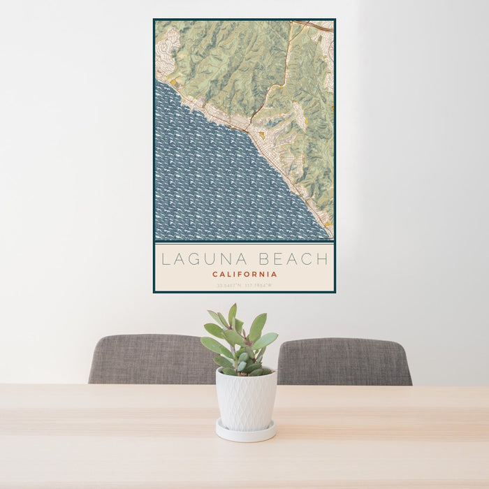 24x36 Laguna Beach California Map Print Portrait Orientation in Woodblock Style Behind 2 Chairs Table and Potted Plant