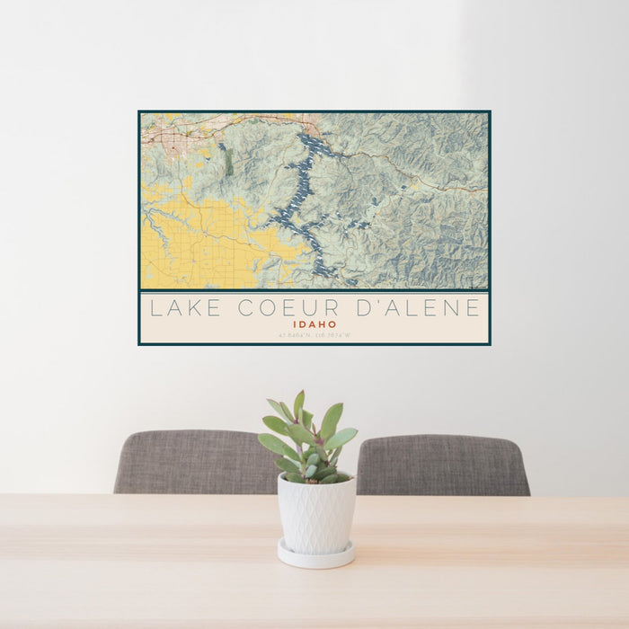 24x36 Lake Coeur d'Alene Idaho Map Print Lanscape Orientation in Woodblock Style Behind 2 Chairs Table and Potted Plant