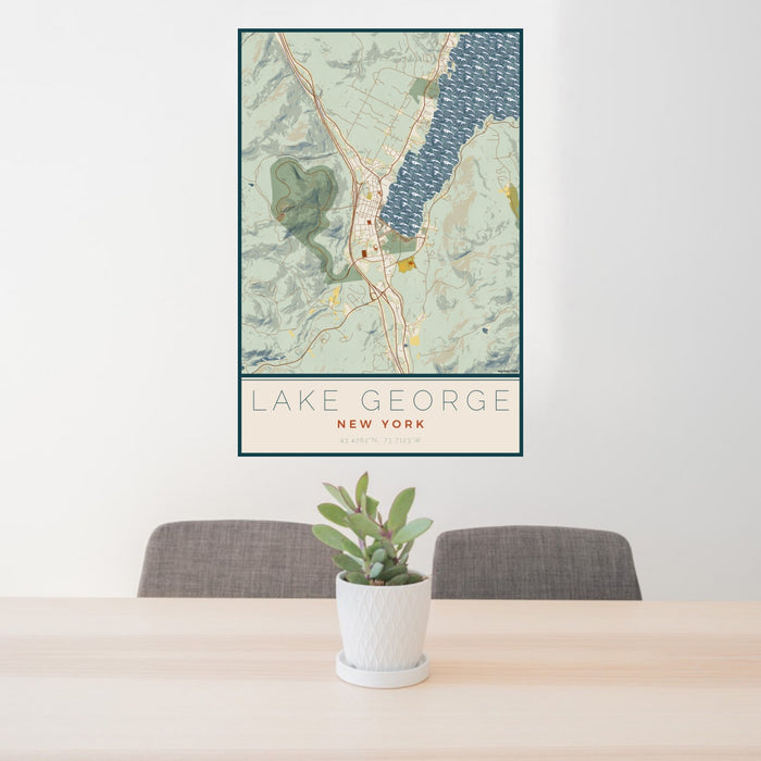 24x36 Lake George New York Map Print Portrait Orientation in Woodblock Style Behind 2 Chairs Table and Potted Plant