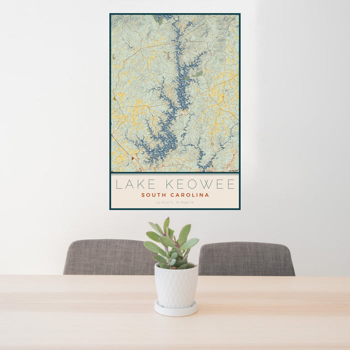24x36 Lake Keowee South Carolina Map Print Portrait Orientation in Woodblock Style Behind 2 Chairs Table and Potted Plant