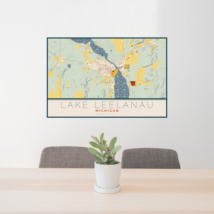 24x36 Lake Leelanau Michigan Map Print Lanscape Orientation in Woodblock Style Behind 2 Chairs Table and Potted Plant