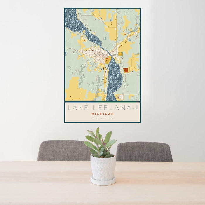 24x36 Lake Leelanau Michigan Map Print Portrait Orientation in Woodblock Style Behind 2 Chairs Table and Potted Plant