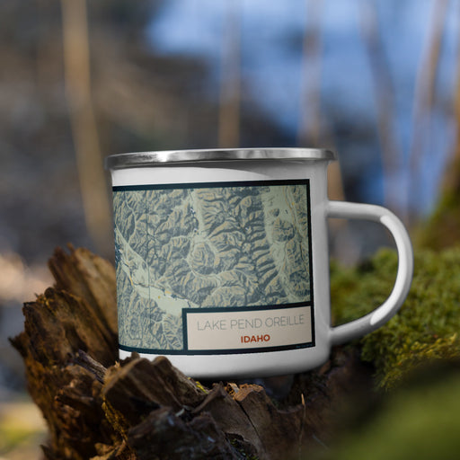 Right View Custom Lake Pend Oreille Idaho Map Enamel Mug in Woodblock on Grass With Trees in Background