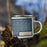 Right View Custom Lakeside Montana Map Enamel Mug in Woodblock on Grass With Trees in Background