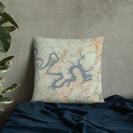 Custom Lake Travis Texas Map Throw Pillow in Woodblock on Bedding Against Wall