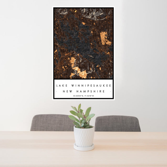 24x36 Lake Winnipesaukee New Hampshire Map Print Portrait Orientation in Ember Style Behind 2 Chairs Table and Potted Plant
