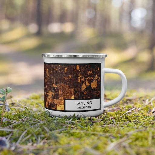 Right View Custom Lansing Michigan Map Enamel Mug in Ember on Grass With Trees in Background