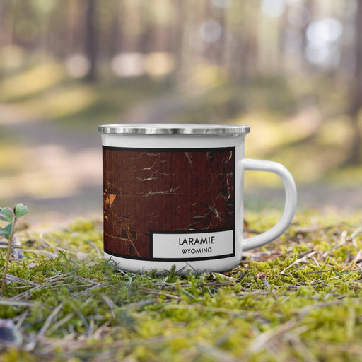 Right View Custom Laramie Wyoming Map Enamel Mug in Ember on Grass With Trees in Background