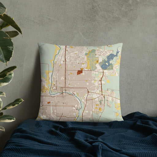 Custom Laredo Texas Map Throw Pillow in Woodblock on Bedding Against Wall