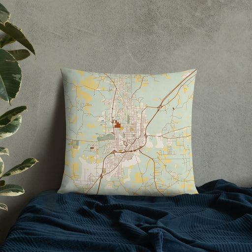 Custom Laurel Mississippi Map Throw Pillow in Woodblock on Bedding Against Wall