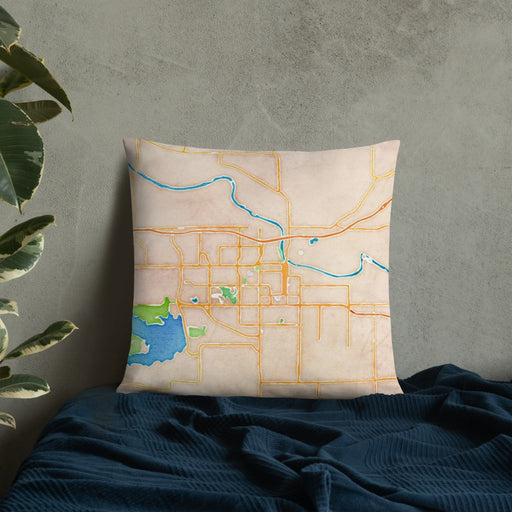 Custom Lawrence Kansas Map Throw Pillow in Watercolor on Bedding Against Wall