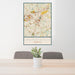 24x36 Lawrenceville Georgia Map Print Portrait Orientation in Woodblock Style Behind 2 Chairs Table and Potted Plant