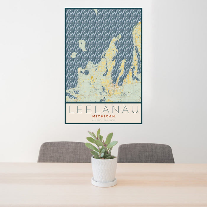 24x36 Leelanau Michigan Map Print Portrait Orientation in Woodblock Style Behind 2 Chairs Table and Potted Plant
