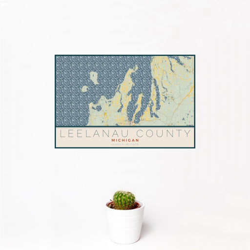 12x18 Leelanau County Michigan Map Print Landscape Orientation in Woodblock Style With Small Cactus Plant in White Planter