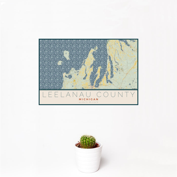 12x18 Leelanau County Michigan Map Print Landscape Orientation in Woodblock Style With Small Cactus Plant in White Planter