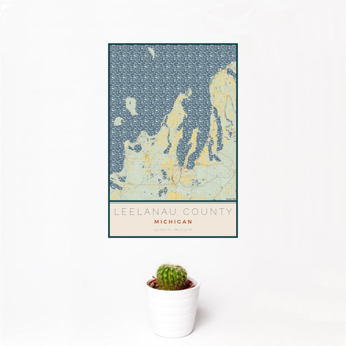 12x18 Leelanau County Michigan Map Print Portrait Orientation in Woodblock Style With Small Cactus Plant in White Planter