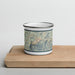 Front View Custom Little Switzerland North Carolina Map Enamel Mug in Woodblock on Cutting Board