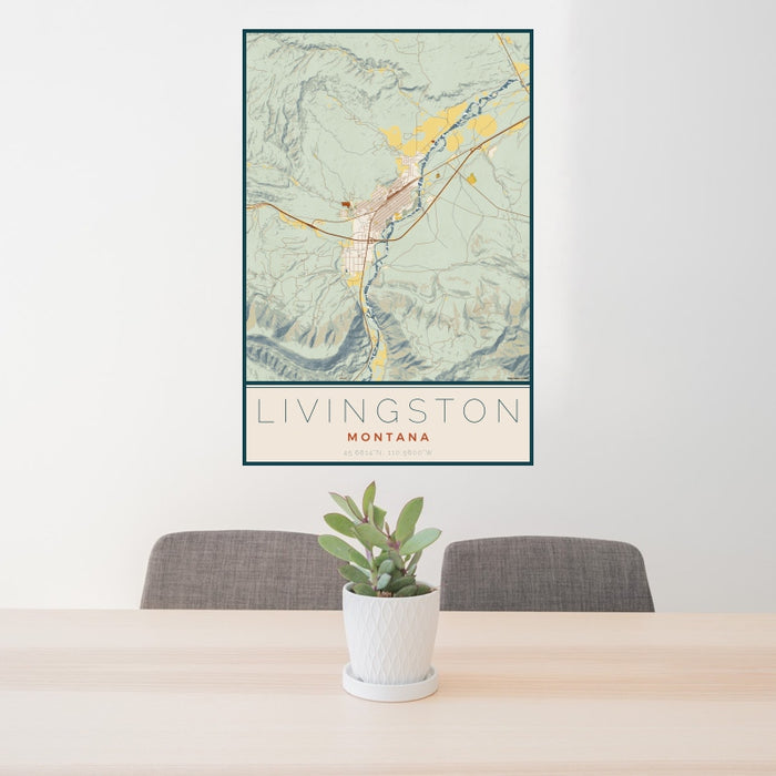 24x36 Livingston Montana Map Print Portrait Orientation in Woodblock Style Behind 2 Chairs Table and Potted Plant