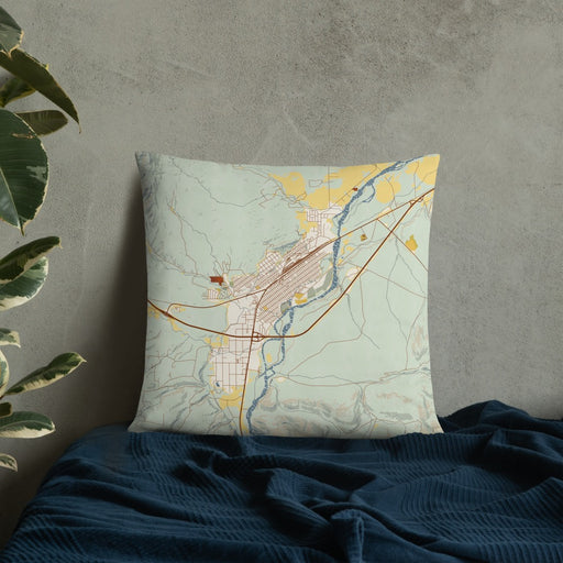 Custom Livingston Montana Map Throw Pillow in Woodblock on Bedding Against Wall