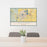 24x36 Loveland Colorado Map Print Landscape Orientation in Woodblock Style Behind 2 Chairs Table and Potted Plant